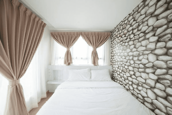 sinar eco resort container room interior with brown curtain and queen size bed