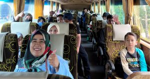 Passengers-on-the-bus-with-smiley-face-cushion-and-travel-happily